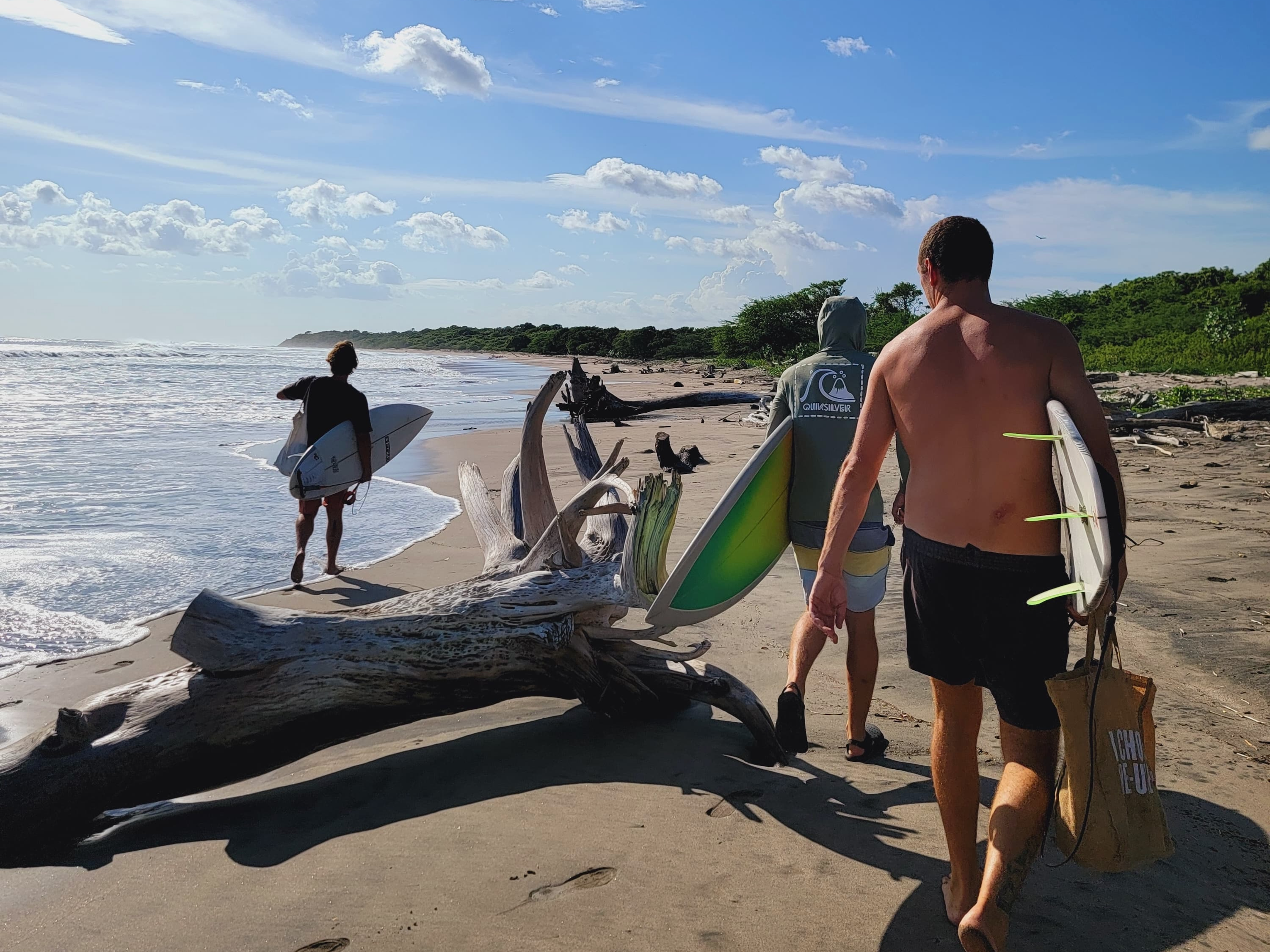 Joe Bouchard, Island Conservation donor, walking on the beach to go surf.